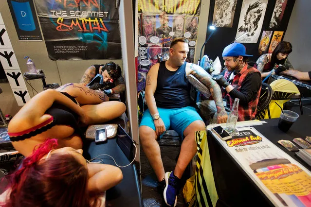 Souvenirs from the show: convention visitors take advantage of the on-site artists to get new tattoos at the International London Tattoo Convention in London, Britain September 23, 2016. (Photo by Linda Nylind/The Guardian)
