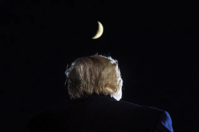 The moon is seen above U.S. President Donald Trump as he delivers a speech during a campaign rally at Toledo Express Airport in Swanton, Ohio, U.S., September 21, 2020. (Photo by Tom Brenner/Reuters)