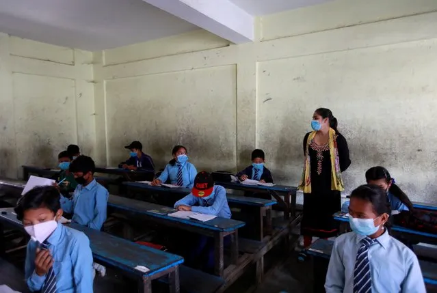 Students, wearing protective masks, maintain social distance as they attend class, amid the coronavirus disease (COVID-19) pandemic in Kathmandu, Nepal on October 4, 2020. (Photo by Navesh Chitrakar/Reuters)