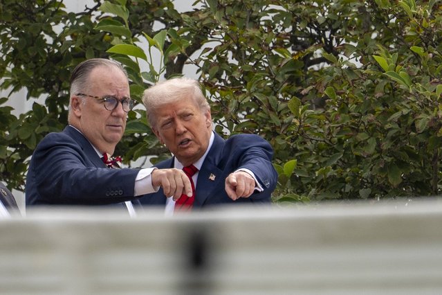 President Donald Trump, with architect James McCrery, left, surveys the grounds from the roof above the Colonnade that goes to the West Wing of the White House, Tuesday, August 5, 2025, in Washington. (Photo by Alex Brandon/AP Photo)