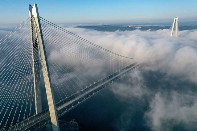 An aerial view of the fog blankets the Yavuz Sultan Selim Bridge in Istanbul, Turkiye on January 02, 2023. (Photo by Ali Atmaca/Anadolu Agency via Getty Images)