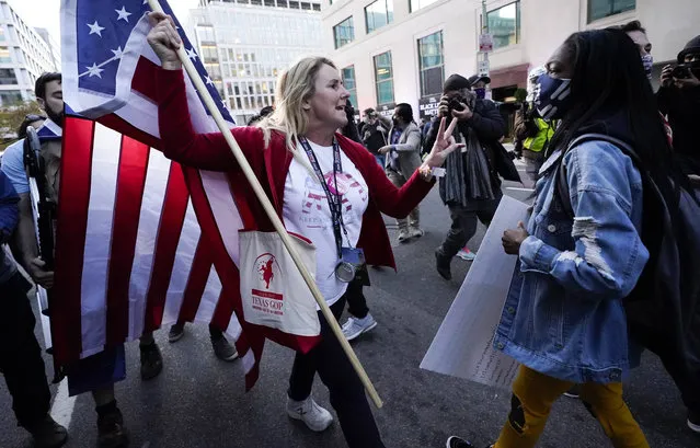 A woman gestures as she argues with a counter-protester after supporters of President Donald Trump held marches Saturday, November 14, 2020, in Washington. (Photo by Julio Cortez/AP Photo)