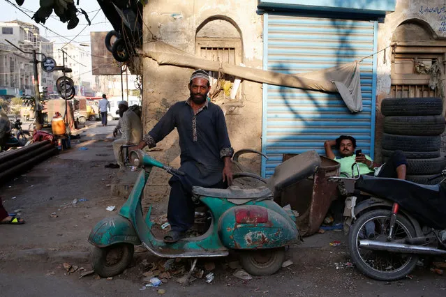 Shahzad stands with his abandoned Vespa scooter in Karachi, Pakistan March 6, 2018. (Photo by Akhtar Soomro/Reuters)