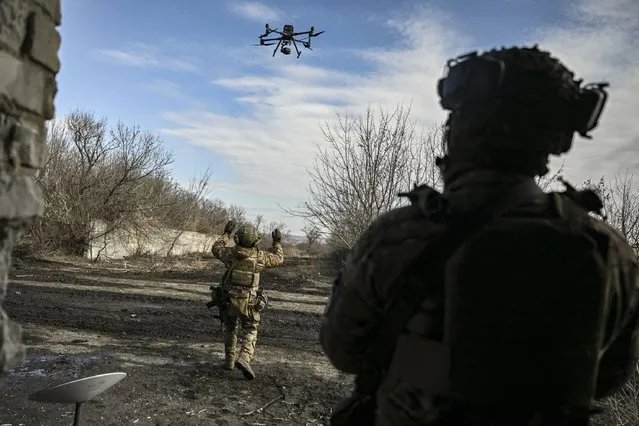 A Ukrainian serviceman flies a drone to spot Russian positions near the city of Bakhmut, in the region of Donbas, on March 5, 2023. (Photo by Aris Messinis/AFP Photo)