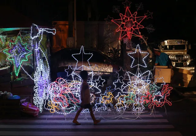 A Filipino boy walks past Christmas decorations for sale in Manila, Philippines on Monday, December 22, 2014. Christmas is one of the most important holidays in this predominantly Roman Catholic nation. (Photo by Aaron Favila/AP Photo)