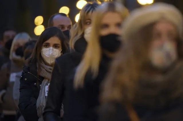 People wear face mask protection to prevent the spread of the coronavirus during a protest in Pamplona, northern Spain, Saturday, December 12, 2020, supporting the hotel industry during the measures enforced to try to control the spread of the coronavirus in the Navarra province, where all bar and restaurants are closed since October, except terrace service. (Photo by Alvaro Barrientos/AP Photo)