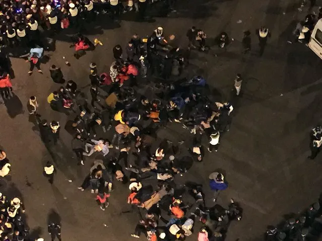 This overhead view shows people being treated at the scene after a stampede by new year's revellers in Shanghai's historic riverfront in Shanghai on January 1, 2015. (Photo by AFP Photo)