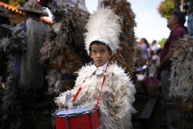 Ignacio Sanchez, dressed in a feathered costume, takes part in a procession celebrating Saint Francisco Solano, in Emboscada, Paraguay, Wednesday, July 24, 2024. Hundreds of Catholic parishioners in Paraguay don bird-like costumes and parade down the streets to honor the 16th century saint said to possess miraculous powers. (Photo by Jorge Saenz/AP Photo)