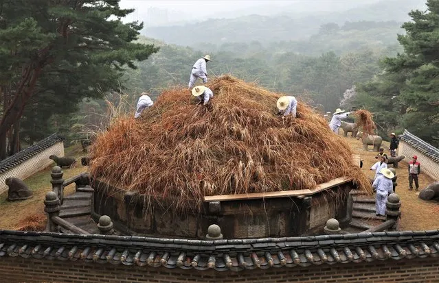 Workers cut the grass at the Geonwonneung tomb of King Taejo, founder of the Joseon Dynasty (1392-1910), in Guri, just east of Seoul, South Korea, on 06 April 2023, marking the Hansik holiday, or the 105th day after the winter solstice. On this day, many Koreans visit their ancestors' tombs to clean them. (Photo by Yonhap/EPA)