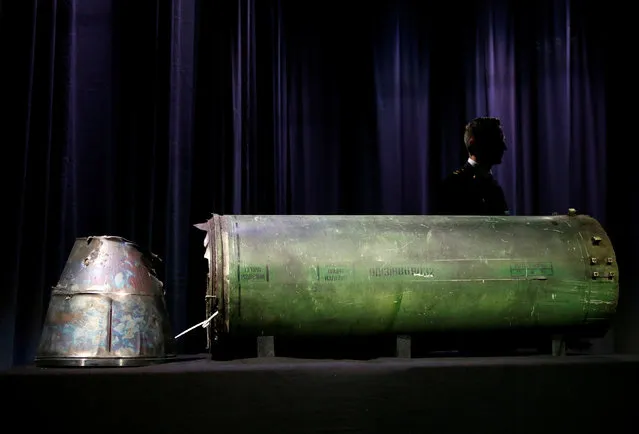 A damaged missile is displayed during a news conference by members of the Joint Investigation Team, comprising the authorities from Australia, Belgium, Malaysia, the Netherlands and Ukraine who present interim results in the ongoing investigation of the 2014 MH17 crash that killed 298 people over eastern Ukraine, in Bunnik, Netherlands, May 24, 2018. Investigators also displayed parts of the engine casing and exhaust system of a Buk 9M38 series missile recovered from eastern Ukraine and showed photos of a unique serial number on the missile. Team members said that careful analysis of video and photos from social media traced the journey of the Russian missile convoy into Ukraine and identified the launcher system. (Photo by Francois Lenoir/Reuters)
