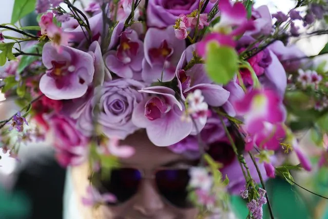 A race fan wears a floral hat on the grounds of Churchill Downs before the start of the 149th running of the Kentucky Oaks horse race in Louisville, Ky., Friday, May 5, 2023. (Photo by Brynn Anderson/AP Photo)