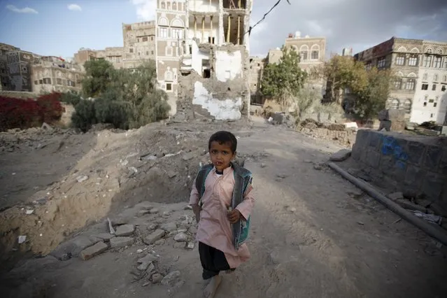 A boy walks past houses damaged in the current conflict in the old quarter of Yemen's capital Sanaa November 27, 2015. (Photo by Khaled Abdullah/Reuters)
