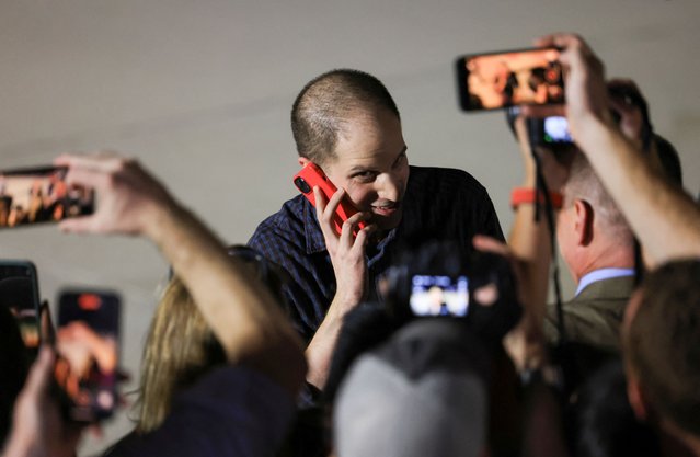 Evan Gershkovich, who was released from detention in Russia, speaks on a mobile phone after disembarking from a plane at Joint Base Andrews in Maryland, U.S., August 1, 2024. (Photo by Kevin Mohatt/Reuters)