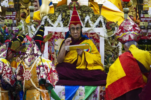 His Holiness, the Dalai Lama wears the red hat during the long life prayer at Tsugla Khang Temple in Mcleodganj, Dharamshala on November 2, 2016. Hundreds of Tibetans-in-exile and Tibetan followers participated in the long life prayer for the Dalai Lama. (Photo by AFP Photo/Stringer)