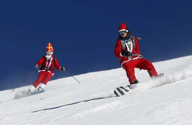 People, dressed as Santa Claus, take a curve during a promotional event on the opening weekend in the alpine ski resort of Verbier, Switzerland, December 6, 2015. (Photo by Denis Balibouse/Reuters)