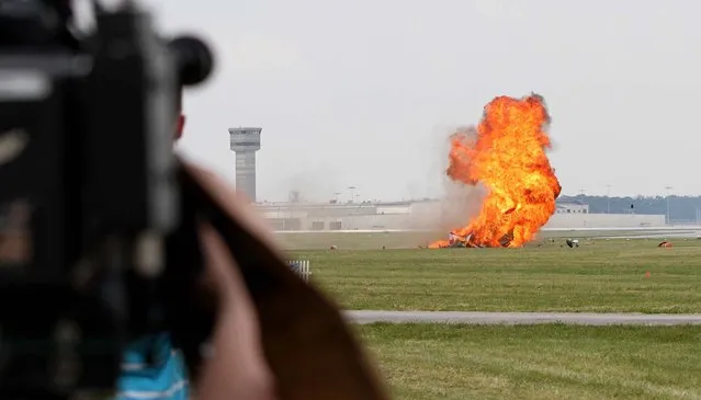 The plane bursts into flames moment after impact. (Photo by Darin Pope/Dayton Daily News)