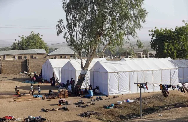 People displaced as a result of Boko Haram attacks in the northeast region of Nigeria, are seen near their tents at a faith-based camp for internally displaced people (IDP) in Yola, Adamawa State January 14, 2015. (Photo by Afolabi Sotunde/Reuters)