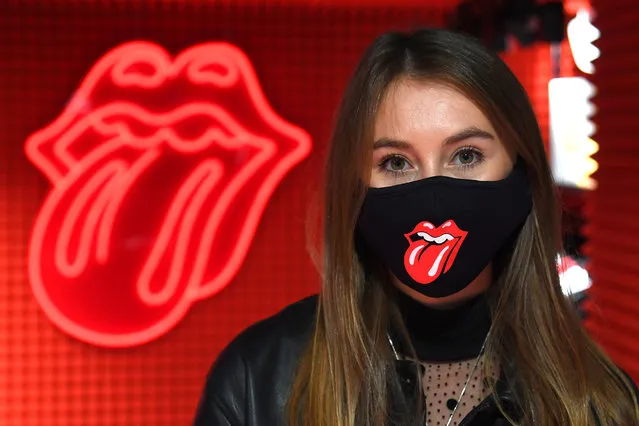 A woman models a Rolling Stones face mask on sale during the Rolling Stones Carnaby Street store opening at RS No. 9 Carnaby on September 08, 2020 in London, England. (Photo by Dave J. Hogan/Getty Images)