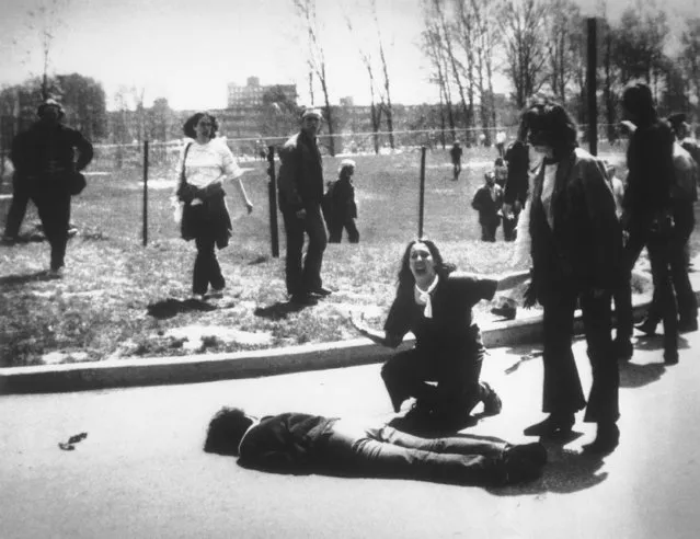 Mary Ann Vecchio gestures and screams as she kneels by the body of a student lying face down on the campus of Kent State University, Kent, Ohio on May 4, 1970. National Guardsmen had fired into a crowd of demonstrators, killing four. (Photo by John Filo/AP Photo)