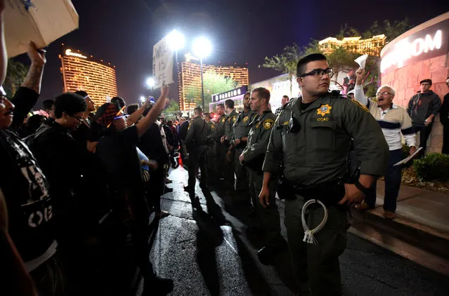 Las Vegas police stand between protesters against and supporters of the election of Republican Donald Trump as President of the United States, near the Trump International Hotel & Tower in Las Vegas, Nevada, U.S. November 12, 2016. (Photo by David Becker/Reuters)
