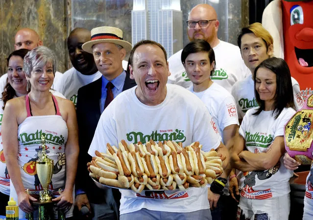 Ten-time and defending Nathan's Famous Men's Champion Joey Chestnut poses with 72 hot dogs during Nathan's Famous International Fourth of July Hot Dog Eating Contest weigh-in at the Empire State Building on Tuesday, July 3, 2018, in New York. (Photo by Evan Agostini/Invision/AP Photo)