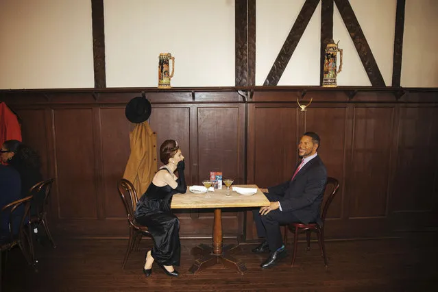 Wax statues of Audrey Hepburn and Michael Strahan occupy one of the tables at Peter Luger Steakhouse on Friday, February 26, 2021, in New York. Five statues, on loan from Madame Tussauds, will occupy unused tables during COVID-19 occupancy restrictions. (Photo by Kevin Hagen/AP Photo)