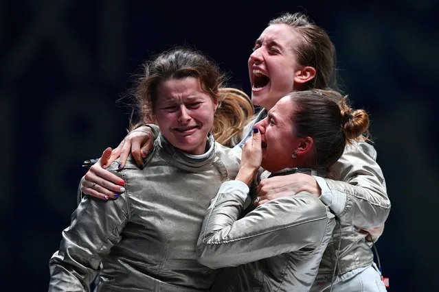 Cecilia Berder of France (L) celebrates with her team after winning the women' s sabre team competition at the 2018 World Fencing Championships in Wuxi in China' s eastern Jiangsu province on July 27, 2018. (Photo by Johannes Eisele/AFP Photo)