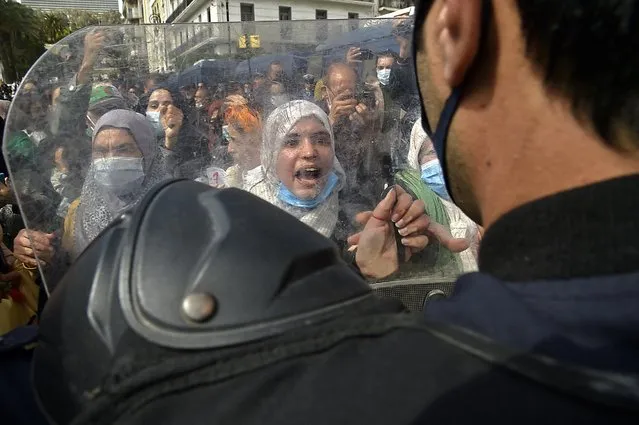 Algerian women chant slogans during an anti-government protest in the capital Algiers on March 8, 2021. Thousands of people demonstrated in Algiers and other cities across the country, confirming the remobilisation of the Hirak protest movement again in the streets since the second anniversary of the uprising on February 22. (Photo by Ryad Kramdi/AFP Photo)