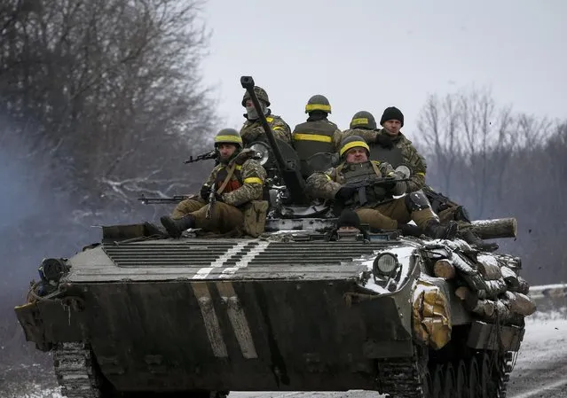 Members of the Ukrainian armed forces ride on an armoured personnel carrier (APC) near Debaltseve, eastern Ukraine, February 10, 2015. (Photo by Gleb Garanich/Reuters)