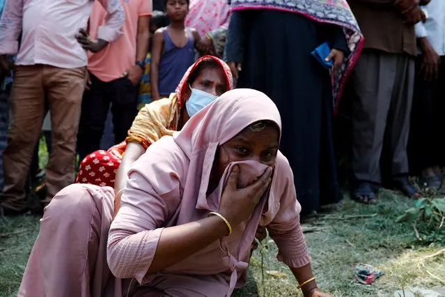 Relatives mourn after several people died as a ferry collided with a cargo vessel and sank on Sunday in the Shitalakhsyaa River in Narayanganj, Bangladesh, April 5, 2021. (Photo by Mohammad Ponir Hossain/Reuters)