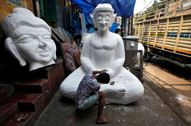 A man works on a Buddha idol made of polystyrene, which will be used to decorate a pandal, or a temporary platform, ahead of the Durga Puja festival in Kolkata, September 25, 2018. (Photo by Rupak De Chowdhuri/Reuters)