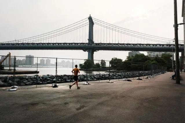 A person jogs through a Brooklyn park on a hazy morning resulting from Canadian wildfires on June 06, 2023 in New York City. Over 100 wildfires are burning in the Canadian province of Nova Scotia and Quebec causing air quality health alerts for New York State and parts of New England. (Photo by Spencer Platt/Getty Images)