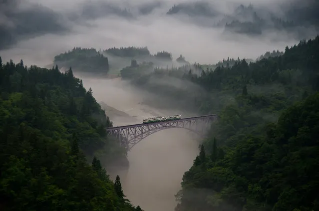 “Taken at Mishima town in Fukushima pref. The first train goes across the railway bridge through in morning mist. The train moves forward little by little slowly. I thought, this sight has expressed the Fukushima people defying to recover from the earthquake and nuclear accident. But it is the uncertain endless journey”. (Photo and caption by Teruo Araya)