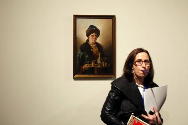 A woman stands next to “Boyar's daughter” by Russian-born artist Nikolai Nevrev during an international press tour of the Malaga branch of the State Museum of Russian Art of St Petersburg, a day before its inauguration in Malaga, southern Spain March 24, 2015. (Photo by Jon Nazca/Reuters)
