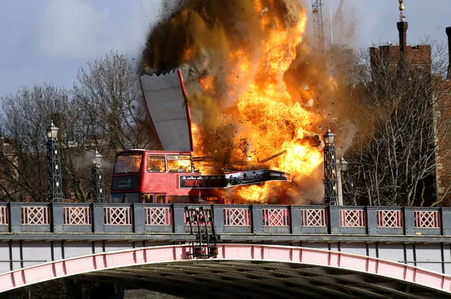 A bus explodes on Lambeth Bridge, during filming for Jackie Chan's new film The Foreigner, in London, Sunday, February  7, 2016. A bus has exploded in central London – but this time it's only for a movie. City officials Sunday reassured the public that the explosion was a movie stunt for “The Foreigner” starring Jackie Chan and Pierce Brosnan. (Photo by Steve Parsons/PA Wire via AP Photo)