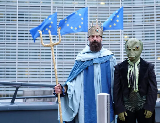 Environmental activists, one dressed as Greek god of the sea Poseidon (L), protest against fishing quotas in front of EU council during a European Agriculture and Fisheries council in Brussels, Belgium, 17 December 2018. Ministers are due to agree on the 2019 fishing opportunities for the Atlantic and North Sea. The Council is responsible for fixing quotas allowable catches and allocating fishing opportunities. Decisions are taken on the basis of a proposal from the European Commission and scientific advice from the international council for the exploration of the sea (ICES). (Photo by Olivier Hoslet/EPA/EFE)