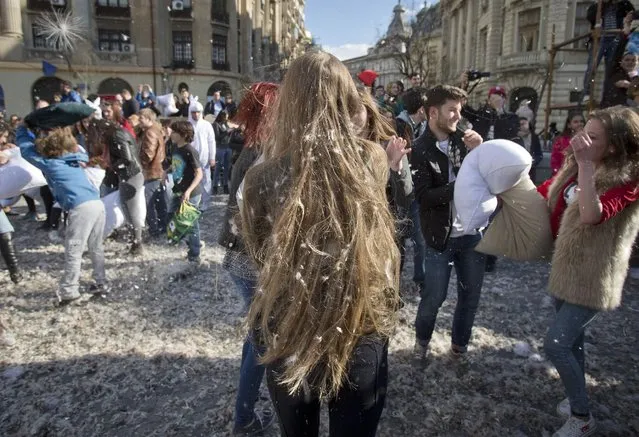 Feathers fly as youngsters engage in a pillow fight downtown Bucharest, Romania, Saturday, April 4, 2015. (Photo by Vadim Ghirda/AP Photo)