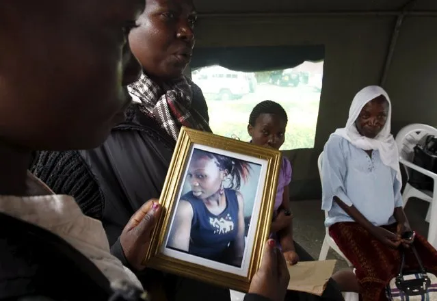 A relative carries a picture of a student killed in Thursday's attack by gunmen, at the Chiromo Mortuary in Kenya's capital Nairobi April 6, 2015. The Kenyan air force has destroyed two al Shabaab camps in Somalia, it said on Monday, in the first major military response since the Islamist group massacred students at a Kenyan university last week. (Photo by Thomas Mukoya/Reuters)