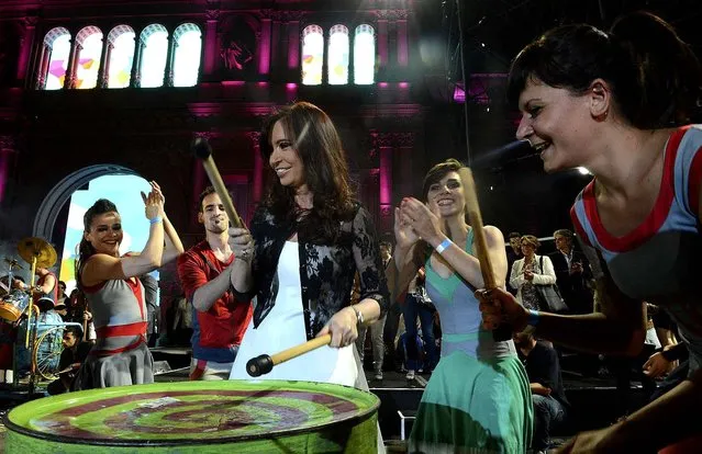 Argentina's President Cristina Fernandez de Kirchner plays drums during celebrations of the 30th anniversary of Argentina's return to democracy at the Casa Rosada Presidential Palace in Buenos Aires, on December 10, 2013. (Photo by Argentine Presidency/Handout via Reuters)
