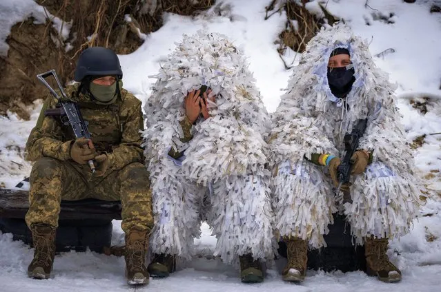 Members of the pro-Ukrainian Russian ethnic Siberian Battalion rest at a military training close to Kyiv, Ukraine, Wednesday, December 13, 2023. Ukraine's military has formed a battalion of soldiers made up entirely of Russian citizens who want to fight against Russian invasion. (Photo by Efrem Lukatsky/AP Photo)