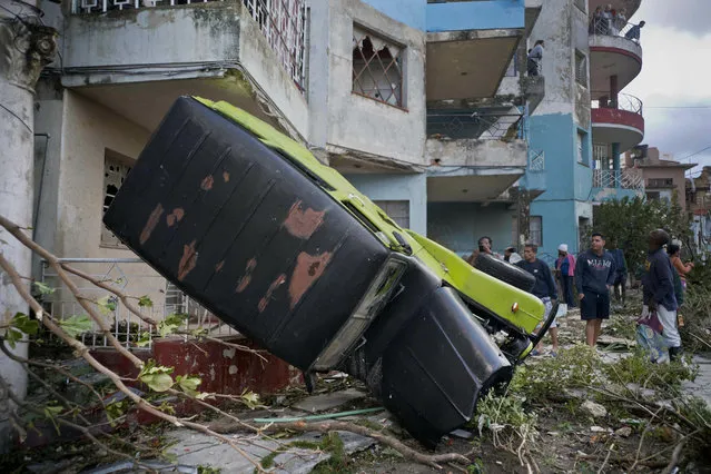 A truck is toppled against a home after a tornado in Havana, Cuba, Monday, January 28, 2019. (Photo by Ramon Espinosa/AP Photo)