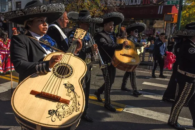 People participate in a Day of the Dead parade on October 30, 2022 in the Sunset Park neighborhood in the Brooklyn borough of New York City. Day of the Dead is a celebratory holiday to remember the dead and this was the first annual Day of the Dead parade sponsored by the Mexican community in Sunset Park.(Photo by Stephanie Keith/Getty Images)