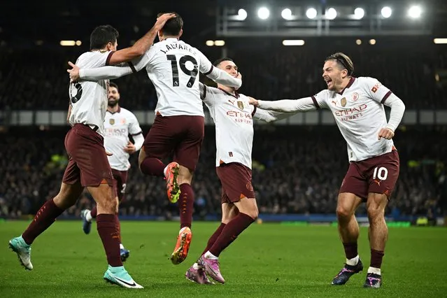 Manchester City's Argentinian striker #19 Julian Alvarez (2nd L) celebrates with teammates after scoring his team second goal during the English Premier League football match between Everton and Manchester City at Goodison Park in Liverpool, north west England on December 27, 2023. (Photo by Paul Ellis/AFP Photo)