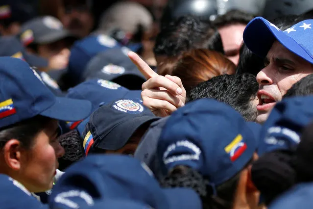 Venezuelan opposition leader and Governor of Miranda state Henrique Capriles (R) takes part in a rally against Venezuelan President Nicolas Maduro's government and to commemorate the 59th anniversary of the end of the dictatorship of Marcos Perez Jimenez in Caracas, Venezuela January 23, 2017. (Photo by Carlos Garcia Rawlins/Reuters)