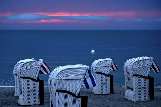 Beach chairs stand at the Baltic Sea in Timmendorfer Strand, Germany, after thunder storms during the night, before sunrise, early Wednesday, June 21, 2023. (Photo by Michael Probst/AP Photo)