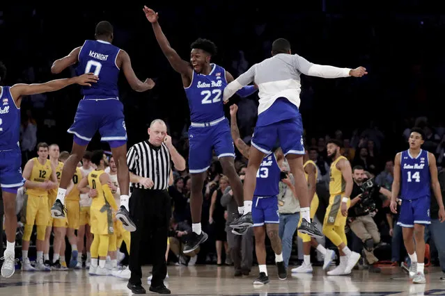 Seton Hall guard Quincy McKnight (0) and guard Myles Cale (22) celebrate after defeating Marquette during an NCAA college basketball semifinal game in the Big East men's tournament, early Saturday, March 16, 2019, in New York. Seton Hall won 81-79. (Photo by Julio Cortez/AP Photo)