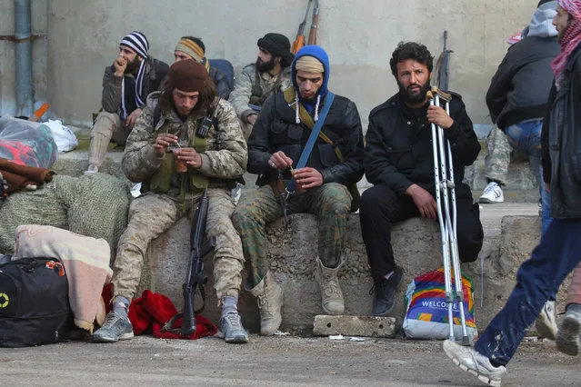 Civilians and rebel fighters that were evacuated from the Wadi Barada valley near Damascus, after an agreement reached on Thursday between rebels and Syria's army, rest upon arrival in the rebel controlled Qalaat al-Madiq town in Hama province, Syria January 30, 2017. (Photo by Omar Sanadiki/Reuters)