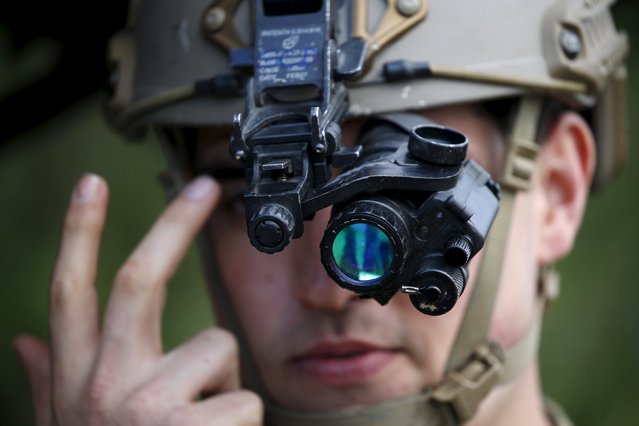 A U.S. Air Force Forward air controller adjusts his night vision goggles during the close air support (CAS) exercise Serpentex 2016 hosted by France in the Mediterranean island of Corsica, March 15, 2016. Serpentex is an annual exercise that involves joint terminal attack controllers (JTACs) from 12 countries from March 7 to March 25, 2016. (Photo by Charles Platiau/Reuters)