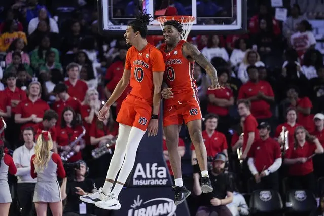 Auburn guards Chad Baker-Mazara (10) and K.D. Johnson (0) celebrate during a timeout in the first half of an NCAA college basketball game against Georgia, Saturday, February 24, 2024, in Athens, Ga. (Photo by John Bazemore/AP Photo)