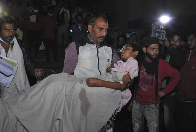 A man carries a child out from the Kamla Nehru Children’s Hospital after a fire in the newborn care unit of the hospital killed four infants, in Bhopal, India, Monday, November 8, 2021. There were 40 children in total in the unit, out of which 36 have been rescued, said Medical Education Minister Vishwas Sarang. (Photo by AP Photo/Stringer)